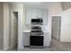 Kitchen area with stainless steel appliances, light gray cabinets and marble backsplash at 947 Bird Bay Ct # 205, Lake Mary, FL 32746