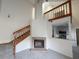 Living room area with a fireplace and a wood staircase leading to the upper level at 947 Bird Bay Ct # 205, Lake Mary, FL 32746