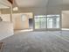 Sunlit living room with large windows, a blue front door, and a full mirrored wall at 947 Bird Bay Ct # 205, Lake Mary, FL 32746