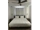 Comfortable bedroom featuring a plush bed, modern lighting, and minimalist decor at 970 N Spring Garden Ave # 621, Deland, FL 32720