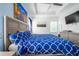 Bright main bedroom featuring a tray ceiling, ceiling fan, art and blue accent wall at 978 E 10Th St, Apopka, FL 32703
