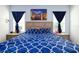 Bedroom featuring light wood furniture, art, and blue accents at 978 E 10Th St, Apopka, FL 32703