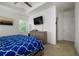 Bright bedroom with a ceiling fan, television, and modern furniture at 978 E 10Th St, Apopka, FL 32703