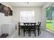 Dining area with natural lighting, a dark wood table, and a sliding glass door to the outdoors at 978 E 10Th St, Apopka, FL 32703