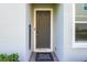 Inviting front door with a 'Sweet Home' welcome mat and attractive exterior paint at 978 E 10Th St, Apopka, FL 32703