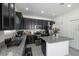 Bright kitchen with dark cabinets, stainless appliances, granite countertops, and a center island at 978 E 10Th St, Apopka, FL 32703