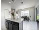 Open kitchen featuring an island and breakfast nook with a dining table and natural lighting at 978 E 10Th St, Apopka, FL 32703