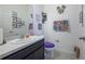 Powder room with vanity, toilet, and decorative wall art at 978 E 10Th St, Apopka, FL 32703