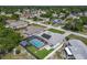 An aerial view of a single Gathering home with a screened in pool, solar panels, and fenced in yard at 1129 Madura Dr, Deltona, FL 32725