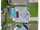 Aerial view of a single Gathering home featuring a large yard, a screened pool, and solar panels at 1129 Madura Dr, Deltona, FL 32725