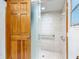 Bathroom featuring a shower with white tile and a sliding glass door at 1129 Madura Dr, Deltona, FL 32725