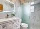Modern bathroom with sleek marble tiles, glass shower, and updated vanity with great lighting at 1129 Madura Dr, Deltona, FL 32725
