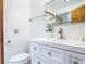 Bathroom featuring a modern vanity, a white floral decoration, and a toilet at 1129 Madura Dr, Deltona, FL 32725