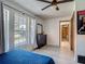 Bright bedroom features wood floors, large windows, and ceiling fan for a comfortable living space at 1129 Madura Dr, Deltona, FL 32725