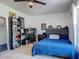 Well-lit bedroom featuring wood-look floors, a ceiling fan, a computer desk, and a bookcase at 1129 Madura Dr, Deltona, FL 32725