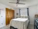 This bedroom features neutral decor, a ceiling fan, and a closet with light wood doors at 1129 Madura Dr, Deltona, FL 32725