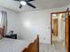 Cozy bedroom featuring an inviting bed, wood accents, and a ceiling fan for added comfort at 1129 Madura Dr, Deltona, FL 32725