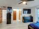 Bright bedroom featuring wood-look floors, a ceiling fan, and an attached hallway at 1129 Madura Dr, Deltona, FL 32725