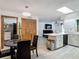 Open-concept dining area and kitchen, featuring wood-look floors and an island with seating at 1129 Madura Dr, Deltona, FL 32725