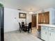 Dining area adjacent to the kitchen with wood-look floors and seating for four at 1129 Madura Dr, Deltona, FL 32725