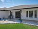 Covered front entrance with seating and white rock accents with planters at 1129 Madura Dr, Deltona, FL 32725