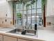 Kitchen sink with double basin and view of the pool outside the window at 1129 Madura Dr, Deltona, FL 32725