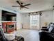 Living room with wood-look floors, a fireplace and a comfortable seating area at 1129 Madura Dr, Deltona, FL 32725