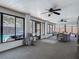 Relaxing sunroom with bright windows, ceiling fans, and a beautiful view of the outdoor pool at 1129 Madura Dr, Deltona, FL 32725