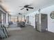Spacious sunroom includes a refrigerator, fan, furniture, and large windows, great for entertaining at 1129 Madura Dr, Deltona, FL 32725