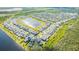 Aerial view showcases a lakeside community with modern homes, serene lake views, and neighborhood landscaping at 11479 Satire St, Orlando, FL 32832