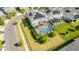 Aerial view of a home with a screened-in pool area, landscaped backyard, and solar panels on the roof at 11479 Satire St, Orlando, FL 32832