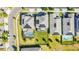 An aerial view of homes with solar panels and screened-in pools in a vibrant neighborhood at 11479 Satire St, Orlando, FL 32832