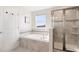Serene bathroom with a soaking tub, separate shower, and neutral tile finishes at 11479 Satire St, Orlando, FL 32832