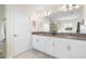 Elegant bathroom featuring double vanities, a large mirror, and modern fixtures at 11479 Satire St, Orlando, FL 32832