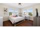 Charming bedroom with three large windows that bring natural light, a desk, and a view of the neighborhood at 11479 Satire St, Orlando, FL 32832