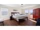 Comfortable bedroom with hardwood floors, natural light, and stylish furnishings, including a queen bed at 11479 Satire St, Orlando, FL 32832