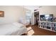 This bedroom has hardwood floors, natural light from a window, and an open closet for storage at 11479 Satire St, Orlando, FL 32832