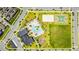 Aerial view showcasing community amenities, including a pool, clubhouse, sports courts and playgrounds at 11479 Satire St, Orlando, FL 32832