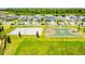 Aerial view of community amenities includes playground, basketball and volleyball courts, and pool for residents at 11479 Satire St, Orlando, FL 32832