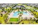 Aerial view showcasing a community pool with palm trees and plenty of lounge chairs for residents at 11479 Satire St, Orlando, FL 32832