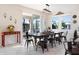 Open dining area with a rustic wood table, ample seating, and sliding glass doors leading to the backyard at 11479 Satire St, Orlando, FL 32832