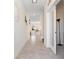 Bright hallway with neutral tile flooring, fresh paint and an open doorway to the main living areas at 11479 Satire St, Orlando, FL 32832