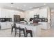 Bright and spacious kitchen with white cabinets, stainless steel appliances, and a center island with seating at 11479 Satire St, Orlando, FL 32832