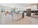 Modern kitchen with sleek countertops, stainless steel appliances, a center island, and ample cabinet space at 11479 Satire St, Orlando, FL 32832