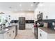 Elegant kitchen featuring white cabinetry, stainless steel appliances, and a spacious island with bar seating at 11479 Satire St, Orlando, FL 32832