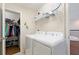 Functional laundry room featuring a washer, dryer, storage shelves, and natural light at 11479 Satire St, Orlando, FL 32832
