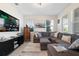 Comfortable living room featuring a large sectional sofa, modern entertainment center, and bright, natural light at 11479 Satire St, Orlando, FL 32832