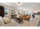 Bright living room featuring modern furnishings, tiled floors, and seamless connection to dining and kitchen areas at 11479 Satire St, Orlando, FL 32832