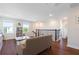 Bright living room with hardwood floors, large windows, and staircase with black metal spindles at 11479 Satire St, Orlando, FL 32832