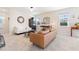 Inviting living room showcases neutral decor, tiled floors, and a stylish console table, creating a welcoming space at 11479 Satire St, Orlando, FL 32832